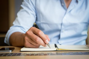 businessman writing restaurant business plan